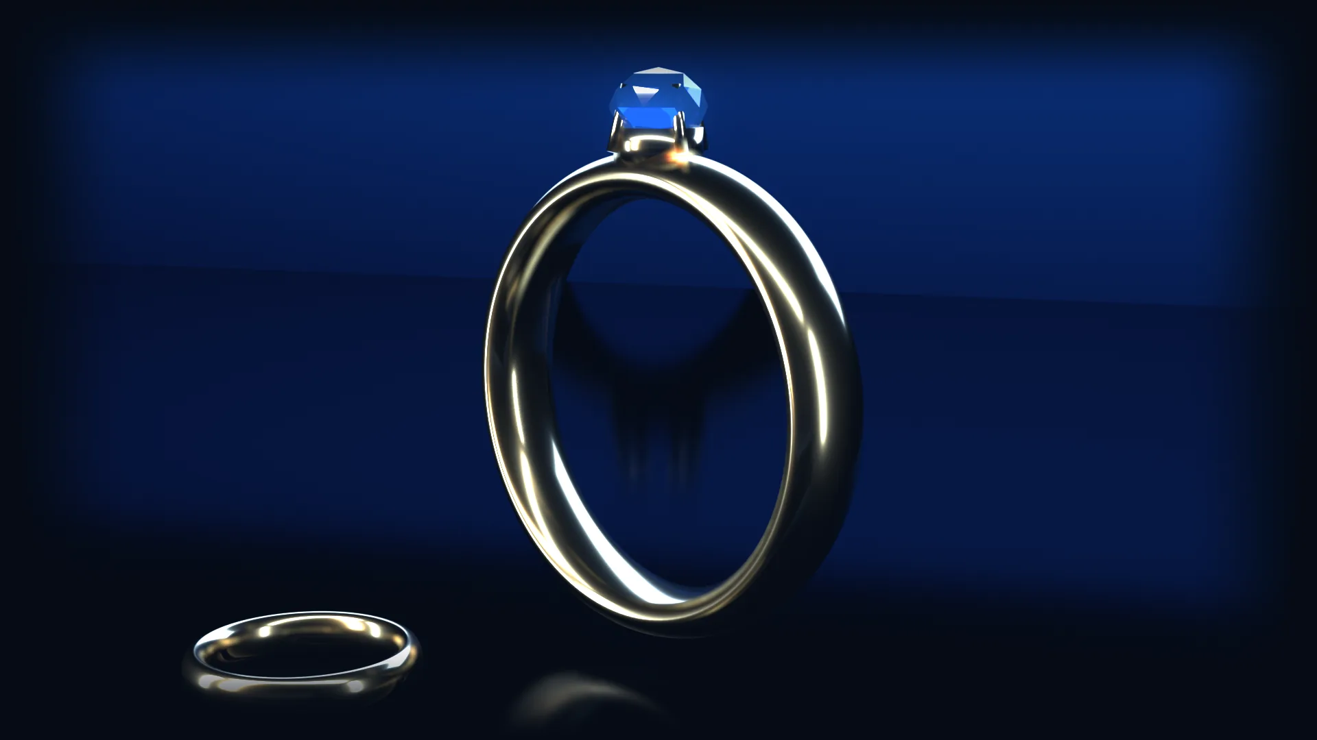 Un anello d'oro con zaffiro e una fede su un pavimento a specchio, illuminati come in uno spot